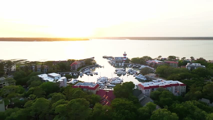 Sunset light over trees and water near harbor town pier, vibrant color tones reflected, Harbour Town Pier South Carolina USA
