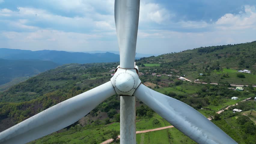 Aerial view of wind turbine in rural Honduras, clean energy infrastructure in Latin America