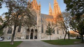 Neo-Gothic Votivkirche, or Votive Church of the 19th century, Vienna, Austria, view of the side facade while vertical panning at autumn sunset
 - Powered by Shutterstock - Get 15% off with code: PIKWIZARD15