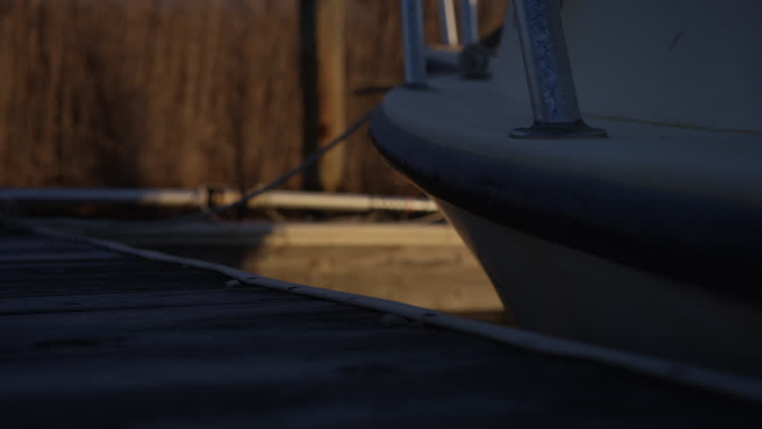Boat moored next to jetty in Long Beach, New Jersey, US