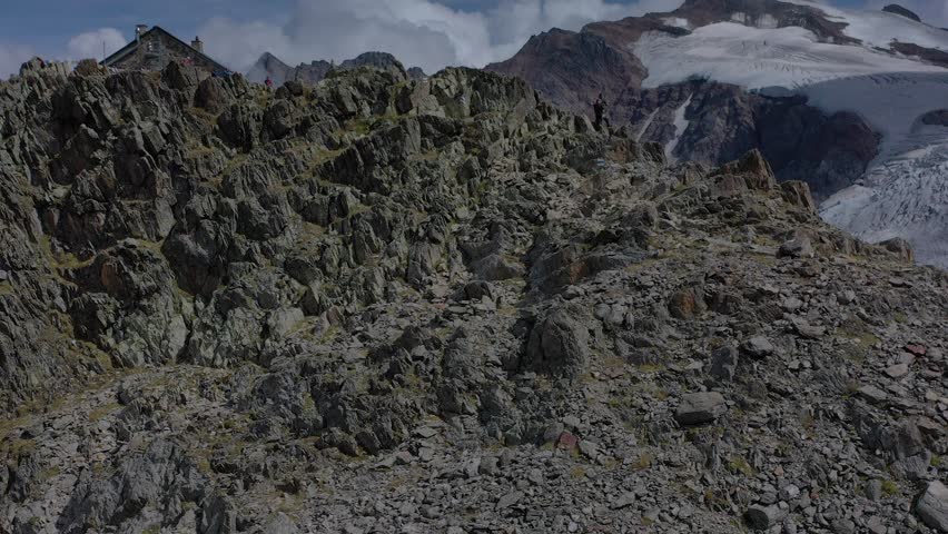 Aerial view of stone glacier steingletscher with rugged mountain terrain and a remote cabin, canton bern, Switzerland.