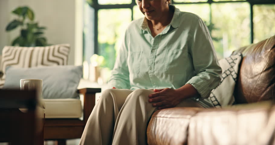 Senior, woman and hands with knee pain, muscle ache or tension for rheumatoid arthritis. Inflammation, osteoporosis or leg injury with circulation issue, joint strain or fibromyalgia swelling in home