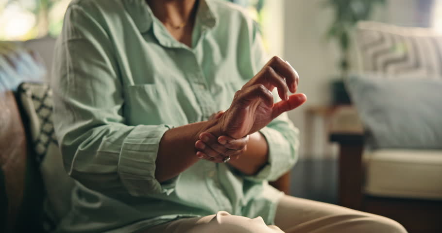 Mature, woman and hand with wrist pain, muscle ache or tension for rheumatoid arthritis. Inflammation, osteoporosis or carpal tunnel syndrome with circulation issue, joint strain or swollen at home