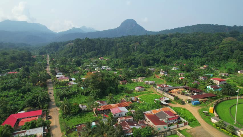Aerial rising view at Santo Antonio city with the mountains at background, at Ilha do Principe (Prince Island) Africa