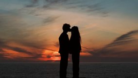 Silhouette Of Couple Kissing The The Beach During Sunset. - aerial shot - Powered by Shutterstock - Get 15% off with code: PIKWIZARD15