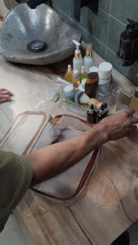 Jump Cut Shot of Person Packing Various Toiletries – 4K Fast-Paced Video of Travel Essentials Being Organized in a Toiletry Bag

