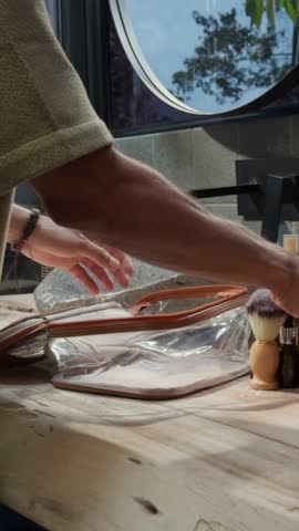 Timelapse Shot of Man Packing Toiletries in Travel Bag – 4K Fast-Paced Video of Travel Preparation with Personal Hygiene Items

