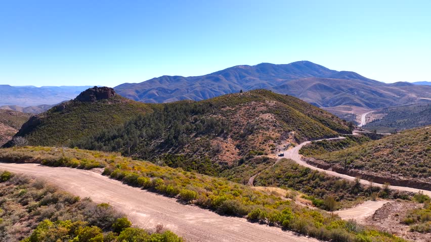 Aerial view of rugged mountains and serene hills with expansive desert landscape, Gila County, Arizona, United States.
