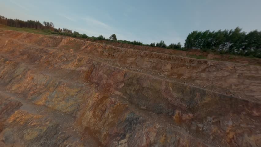 Sedimentary rock exploitation mine next to a forest in Kielce, Poland. Devonian limestone layers.