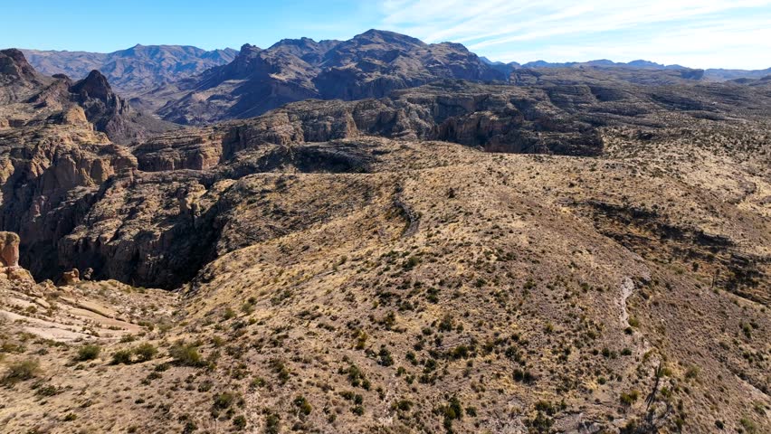 Aerial view of rugged rock formations and a majestic canyon in a vast desert landscape, Apache Junction, Pinal County, Arizona, United States.