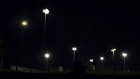 Baseball fields lit up by bright lights at night - Powered by Shutterstock - Get 15% off with code: PIKWIZARD15