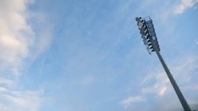 A stadium light pole stands tall as dusk begins - Powered by Shutterstock - Get 15% off with code: PIKWIZARD15