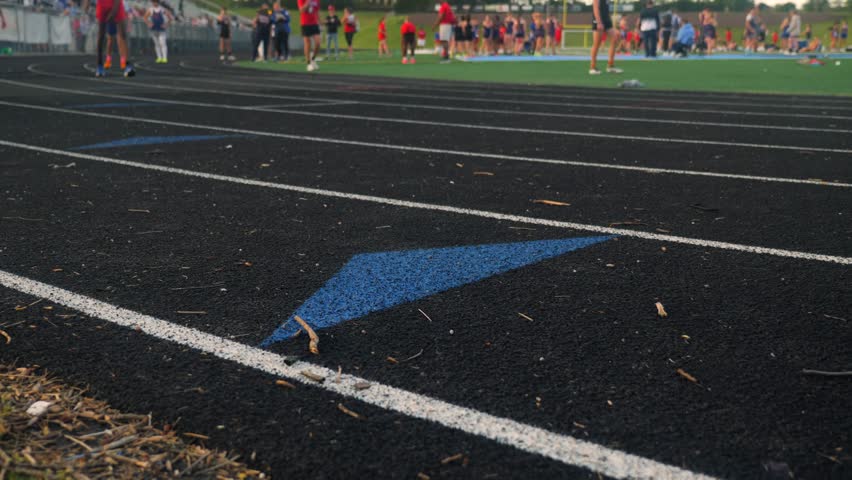 Close shot of race lanes on a running track at a high school sports stadium