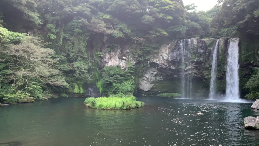 Cheonjiyeon Falls. Water is flowing, falling into the lake. Famous tourist attraction, recreation area on Jeju island. Seogwipo, Jeju Island, South Korea
