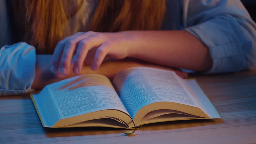 Close-up of Young Woman s Hands Turning Pages of Holy Bible on Table by Candlelight. Peaceful Atmosphere, Quiet Evening Prayer, Hands Folded in Worship, Deep Faith and Spiritual Reflection.