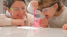 Caucasian Woman and Preschooler Daughter Child Girl Wearing Protective Glasses Having Fun Preparing Science Experiment on Kitchen Table using Education Kit for Homeshooling Learning - Powered by Shutterstock - Get 15% off with code: PIKWIZARD15