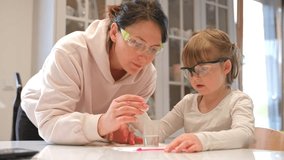 Caucasian Woman and Preschooler Daughter Child Girl Wearing Protective Glasses Having Fun Preparing Science Experiment on Kitchen Table using Education Kit for Homeshooling Learning - Powered by Shutterstock - Get 15% off with code: PIKWIZARD15