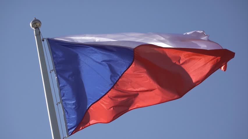 Czech flag waving in strong wind with blue sky