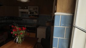 Panoramic view of an old rustic kitchen. View of the kitchen table and a bouquet of poppies and wildflowers. Old rustic window. Concept of an old country kitchen - Powered by Shutterstock - Get 15% off with code: PIKWIZARD15