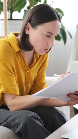Remote Worker Managing Paperwork Online At Home
