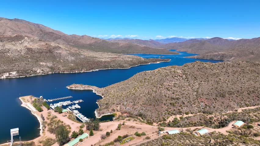Aerial view of apache lake surrounded by rocky mountains and arid desert landscape, apache junction, arizona, united states.