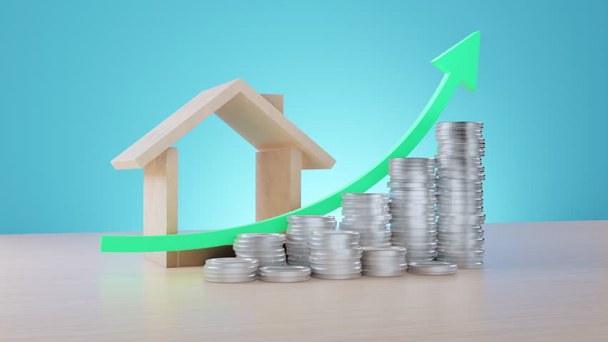A visual representation of real estate investment growth featuring a wooden house model, stacks of silver coins, and a large green arrow pointing upward on a wooden surface.