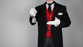 Butler in Formal Attire and White Gloves Ringing Bell. Ring for Service. Professional Hospitality and Courtesy. - Powered by Shutterstock - Get 15% off with code: PIKWIZARD15