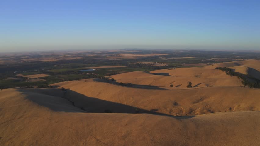 Aerial view of scenic hills and dry fields under a beautiful sky, Barossa Valley, South Australia, Australia.