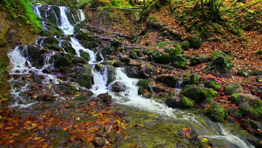 Yedigoller Bolu Turkey Stunning Autumn Waterfall Cascading Over Rocks in a Forest. A breathtaking video of a cascading waterfall flowing over rocks in a lush forest setting. Turkiye Camping area HD