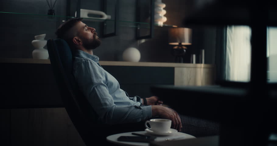 Professional Stock Exchange Broker Sitting in Chair with Eyes Closed, Relaxing After Work and Successful Trading Day. Investment Agent in Modern Home Office or Financial Agency Office. Dolly Shot.