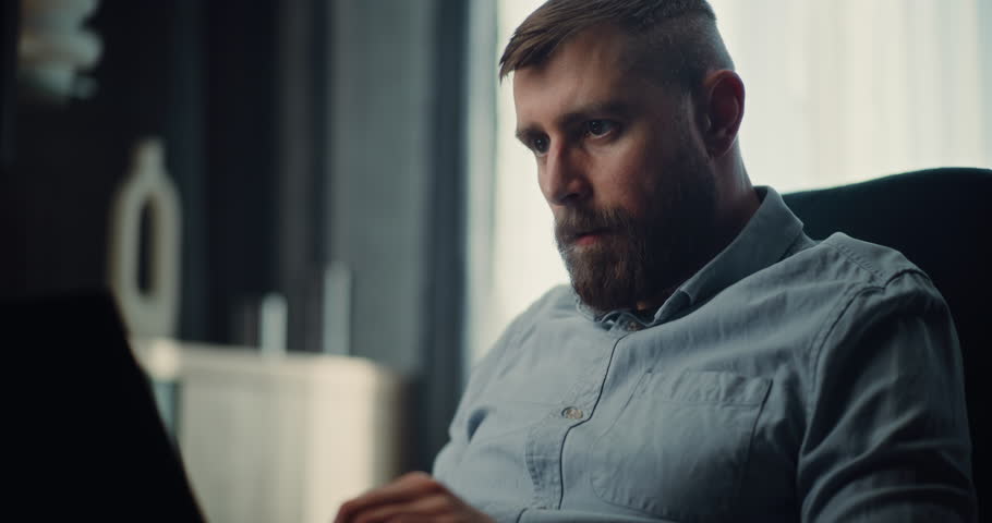 Concentrated Professional Stock Exchange Broker Using Laptop, Monitoring Real-Time Stocks and Exchange Market Charts. Successful Investment Agent Working on Trading in Cozy Office of Financial Agency.