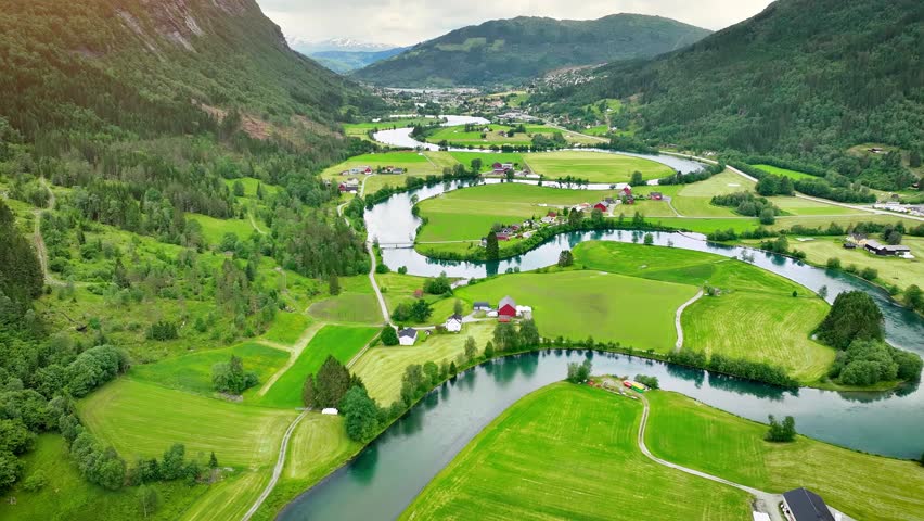 Aerial of a river winding through meadows and farmland near the town of Stryn Norway.