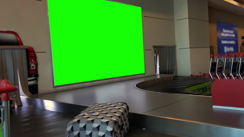 Terminal Interior With Suitcase Conveyor and Green Display, Zoom In Shot, 4K