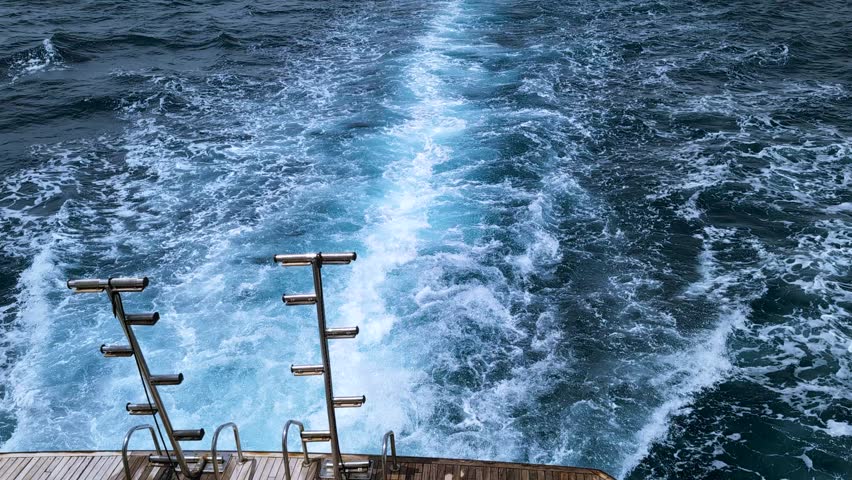 Private yacht view of cruise ship engine tracks in deep blue water with white foam. Relaxing travel concept, warm Red Sea scenery. Voyage and leisure theme, Serene maritime travel atmosphere