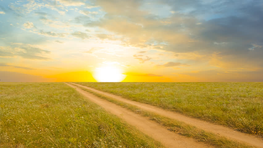 ground road among a prairie at the sunset time lapse scene