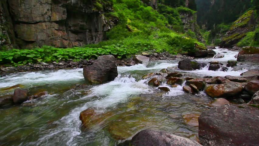 Serene mountain stream flowing through rocky gorge.A tranquil video of a mountain stream cascading over rocks in a lush, green gorge. Trabzon Rize Turkey Turkiye travel holiday Blacksea Karadeniz area