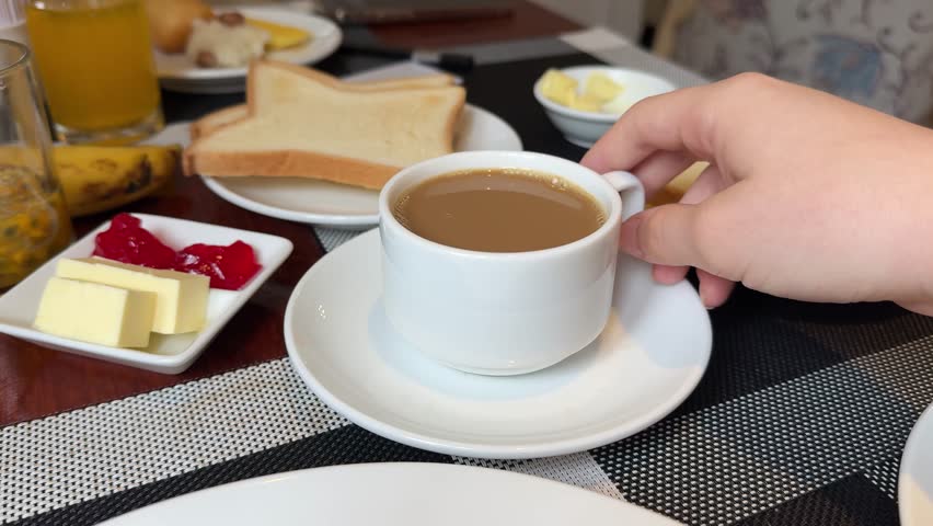 Breakfast in restaurant - fresh pastries, fruits, omelette, toast, yogurt and cup of coffee on wooden table. Good morning in hotel