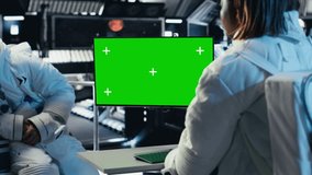 Team of cosmonauts calibrating starship sensors using isolated screen monitor, preparing for mission. Astronauts using chroma key display, beginning landing procedures on solar system planet, camera B - Powered by Shutterstock - Get 15% off with code: PIKWIZARD15