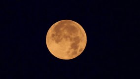 Nasa Full orange moon, glowing brightly in the dark night sky. A stunning close-up view of a full moon, displaying a warm, orange hue against a deep black night sky. HD video  - Powered by Shutterstock - Get 15% off with code: PIKWIZARD15