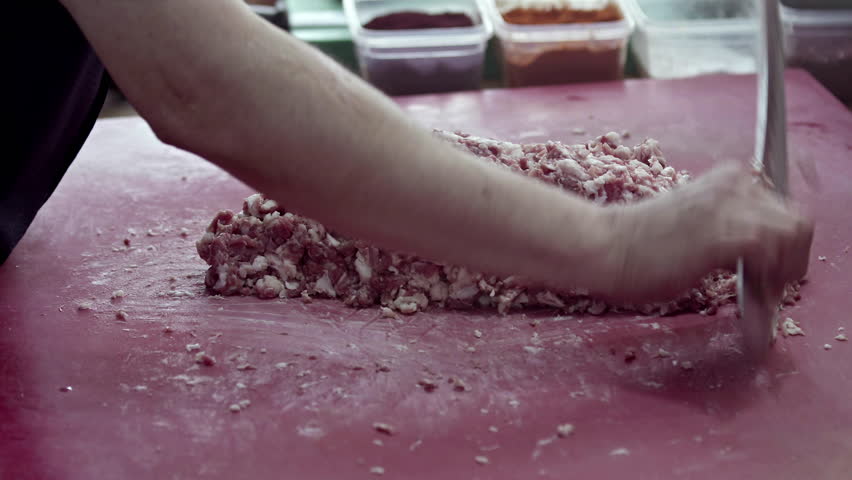 Butcher Cuts Lamb Meat into Minced Meat with a Cleaver Footage.
