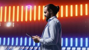 Cool person standing beneath glowing neon lights surrounded by vibrant colors and a futuristic atmosphere. Express individuality, urban style and creative attitude in a nightlife scene. Camera A. - Powered by Shutterstock - Get 15% off with code: PIKWIZARD15