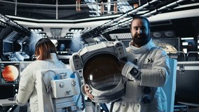 Portrait of joyful astronaut holding helmet doing scheduled operations in starship exploring deep space. Upbeat cosmonaut inspecting spacecraft hull after leaving planet, camera A - Powered by Shutterstock - Get 15% off with code: PIKWIZARD15