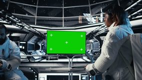 Team of cosmonauts calibrating starship sensors using isolated screen monitor, preparing for mission. Astronauts using chroma key display, beginning landing procedures on solar system planet, camera A - Powered by Shutterstock - Get 15% off with code: PIKWIZARD15