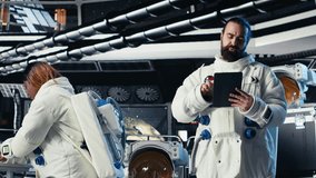 Cosmonaut verifying navigation coordinates on tablet in spaceship during mankind survival expedition. Astronauts calibrating sensors, verifying human expansion in space mission parameters, camera B - Powered by Shutterstock - Get 15% off with code: PIKWIZARD15
