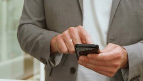 Mid aged man tapping smartphone visualizing secure ecommerce network with blue cart and lock icons. Technology, connectivity, cybersecurity, digital, communication, innovation, business - Powered by Shutterstock - Get 15% off with code: PIKWIZARD15