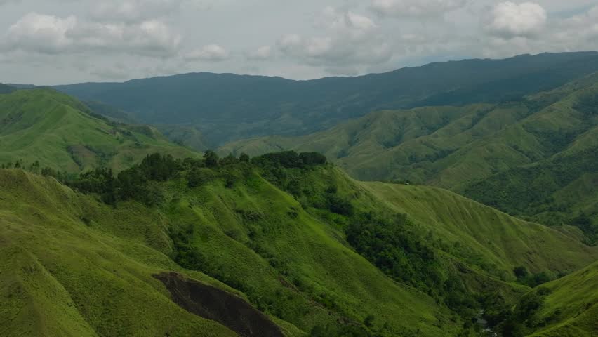 Aerial view of green mountain slopes and forest. Mindanao, Philippines.