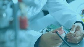 Lab technician grabbing iron and soldering on pad while data fading and scanning circuit board. Electronics, engineering, precision, innovation, diagnostics, technology, workspace - Powered by Shutterstock - Get 15% off with code: PIKWIZARD15