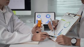 Two doctors are looking at a chart and one of them is holding a bottle of medicine. The chart has graphs and numbers on it - Powered by Shutterstock - Get 15% off with code: PIKWIZARD15