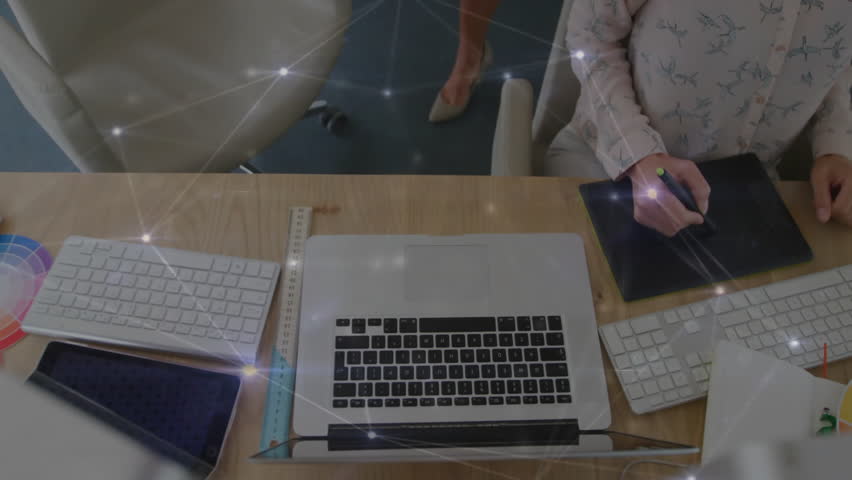 Designers collaborating, one entering pointing at tablet typing on keyboard as colleague sketching. Creative, teamwork, digital art, office, minimalism, innovation, productivity - Powered by Shutterstock - Get 15% off with code: PIKWIZARD15