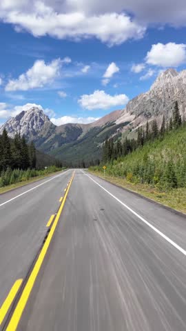 Driving Through Majestic Mountains on a Scenic Highway in British Columbia, Canada on a Sunny Day
